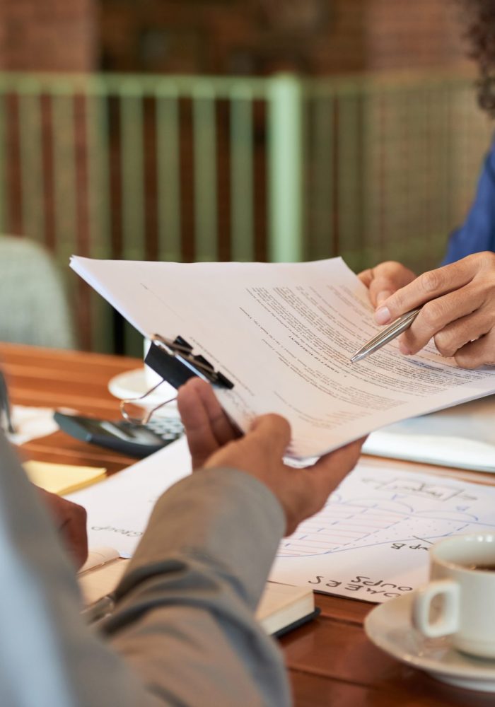 Businessman consulting with lawyer before signing contract